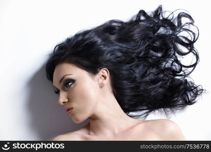 Young girl with beautiful hair on a white background
