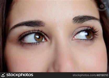 Young girl with brown eyes thinking while looking to the side