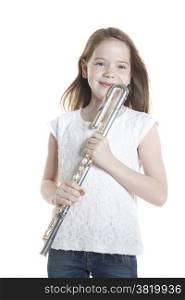 young girl with brown hair holds flute in studio against white background