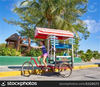 Young girl with caribbean bicycle shop on tricycle of Mexico