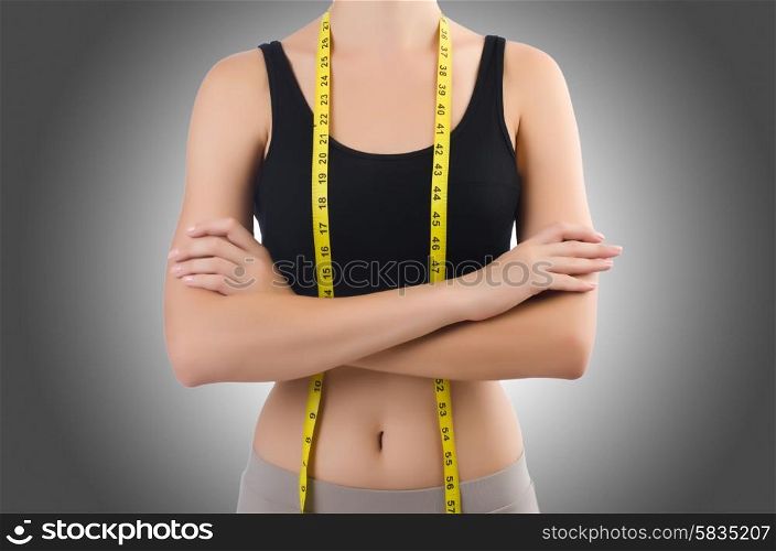 Young girl with centimeter in dieting concept