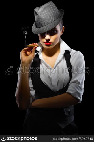 Young girl with cigar on black