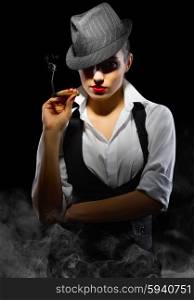 Young girl with cigar on black