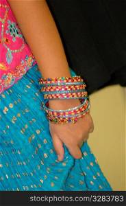 Young girl with colorful bracelets.