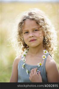 Young girl with daisy chain necklace