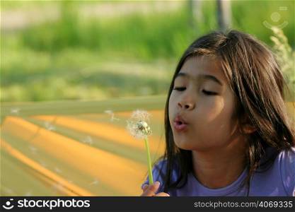 Young girl with dandelion