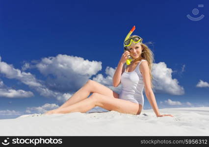 Young girl with diving mask on the beach