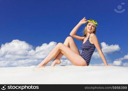 Young girl with diving mask on the beach