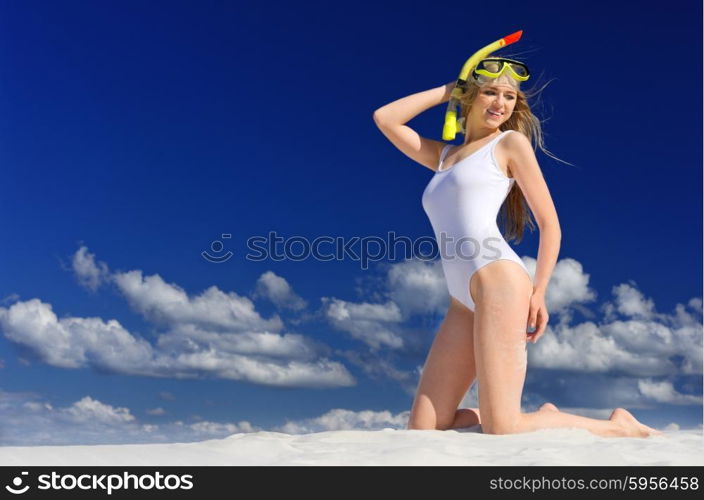 Young girl with diving mask on the beach