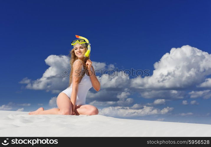 Young girl with diving mask on the beach