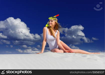 Young girl with diving mask on the beach