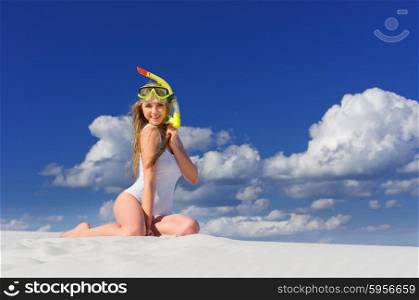 Young girl with diving mask on the beach