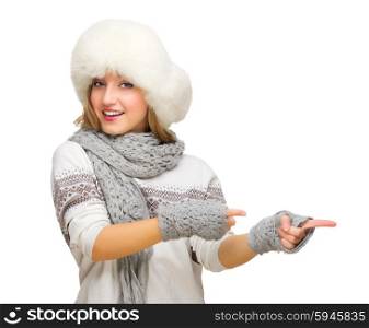 Young girl with fur hat showing pointing background isolated