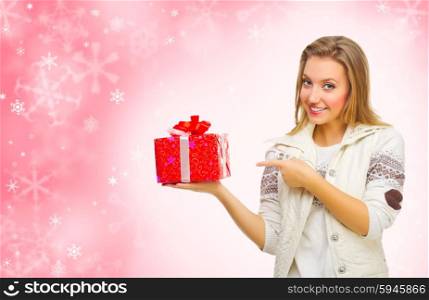 Young girl with gift box on red winter background