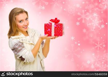 Young girl with gift box on winter background