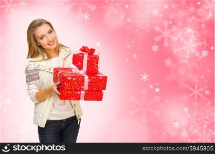 Young girl with gift boxes on red snowy background