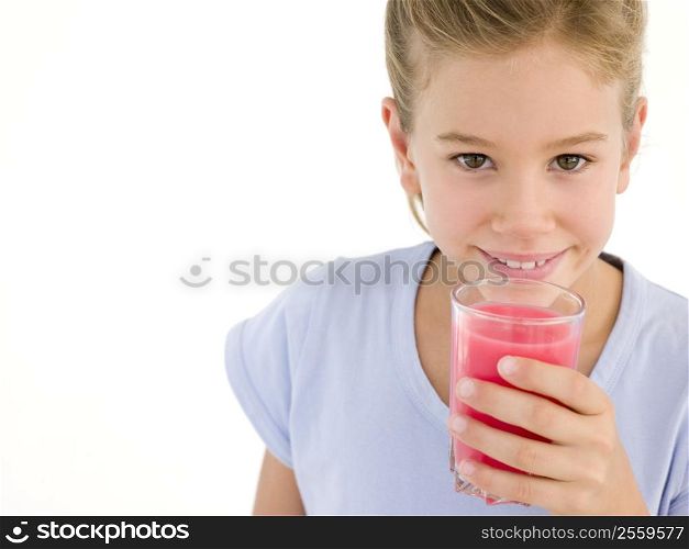 Young girl with glass of juice smiling