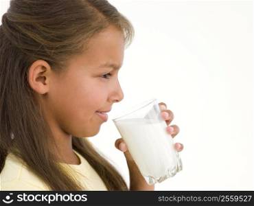 Young girl with glass of milk smiling