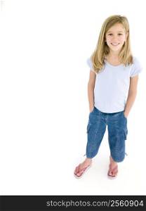 Young girl with hands in pockets smiling
