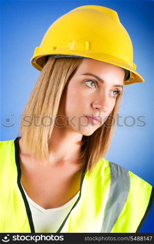 Young girl with hard hat against background