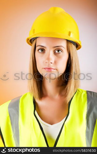 Young girl with hard hat against background