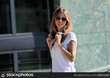 Young girl with headphones and sunglasses dancing in the street