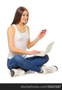 Young girl with laptop and credit card isolated