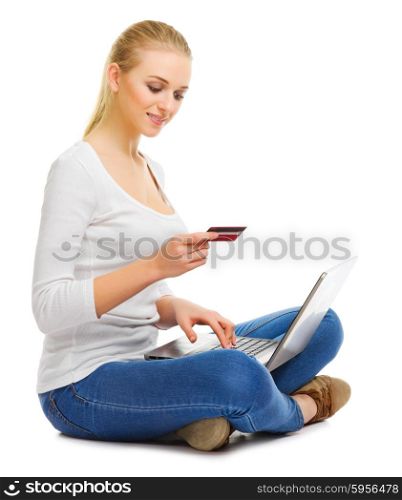 Young girl with laptop and plastic card isolated