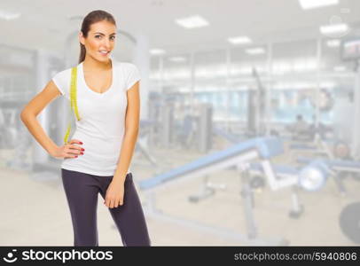 Young girl with measurement tape at gym club