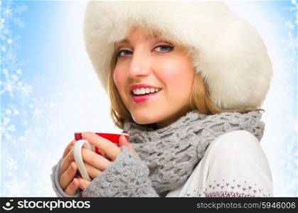Young girl with mug on blue winter background
