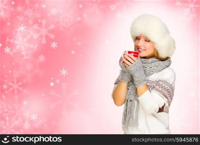 Young girl with mug on red snowy background