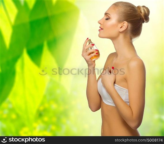 Young girl with perfume on spring floral background