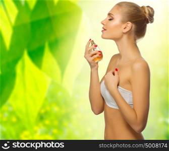 Young girl with perfume on spring floral background