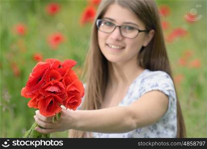 Young girl with poppy bouquet on field