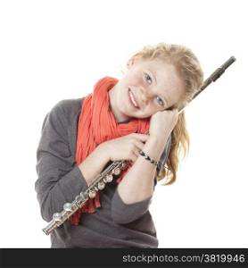 young girl with red hair and freckles with flute in studio against white background