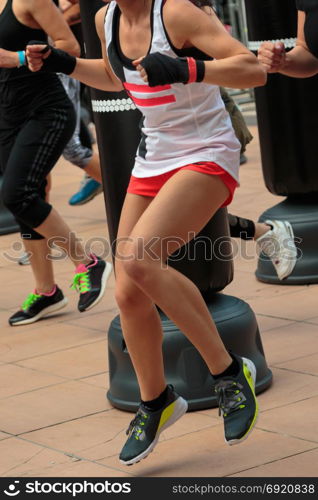 Young Girl with Shorts and White Tank Top: Fitness Boxing Workout with Punching Bag