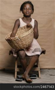 young girl with straw basket sitting chair