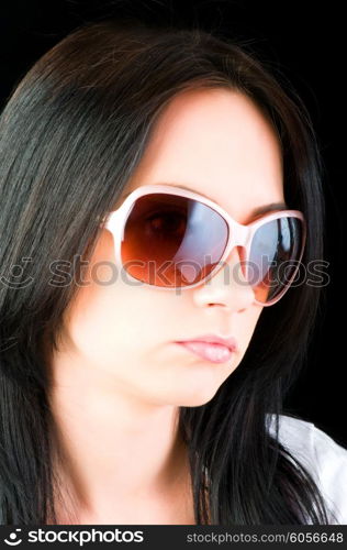 Young girl with sunglasses isolated on black