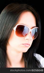 Young girl with sunglasses isolated on black
