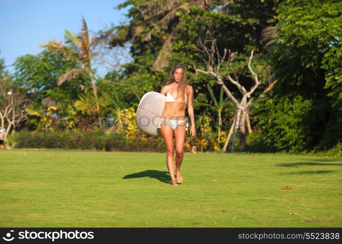 young girl with surfboard