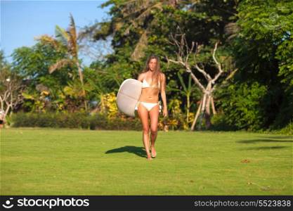 young girl with surfboard