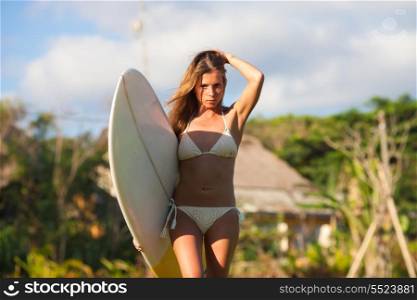 young girl with surfboard