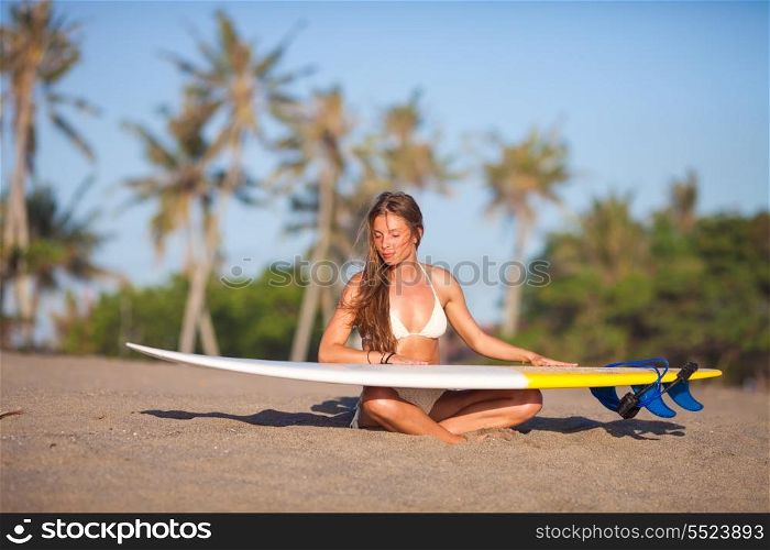 young girl with surfboard at the beach.Bali.Indonesia.