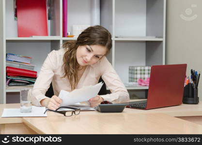 Young girl working at the desk in the office