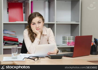 Young girl working at the desk in the office