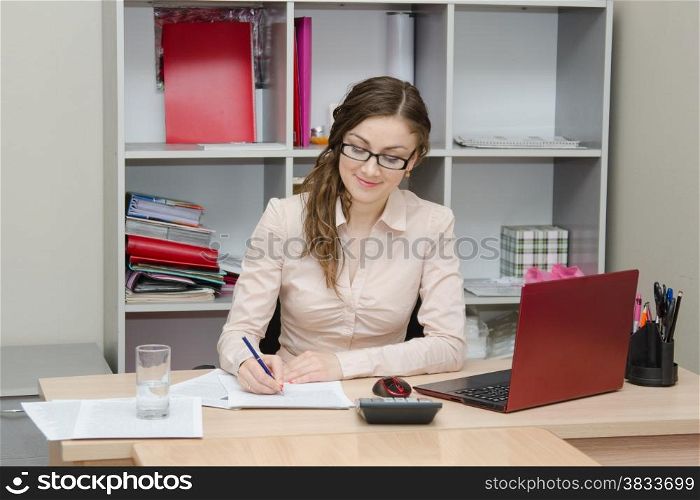 Young girl working at the desk in the office