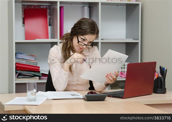 Young girl working at the desk in the office