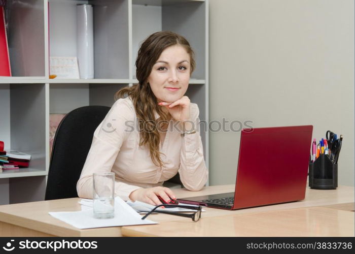 Young girl working at the desk in the office