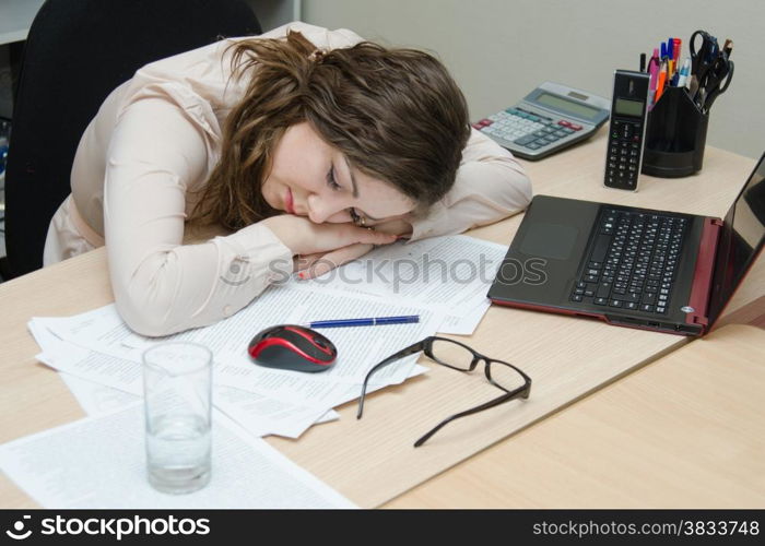 Young girl working at the desk in the office