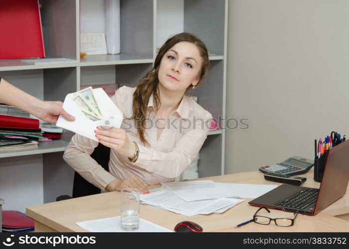 Young girl working at the desk in the office